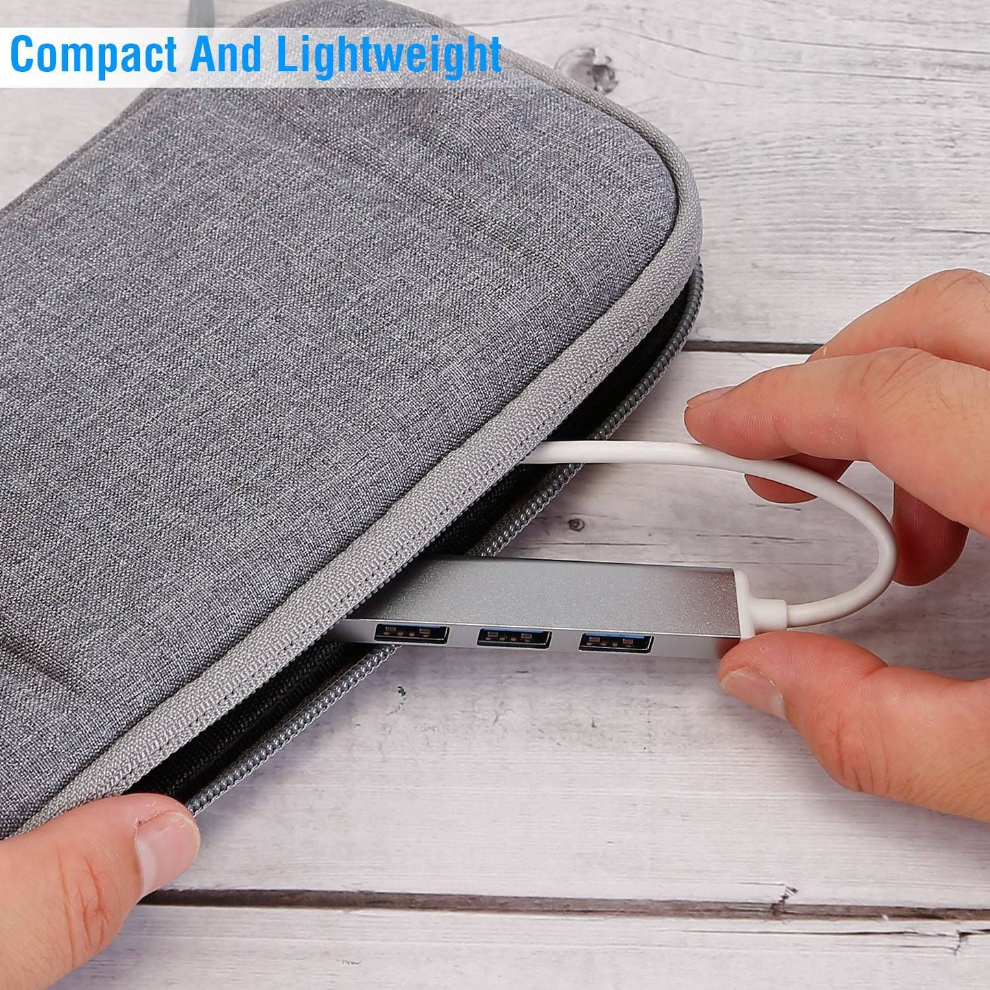 Compact gray electronics organizer case with a USB hub partially visible, demonstrating its lightweight design and practicality for tech accessories.