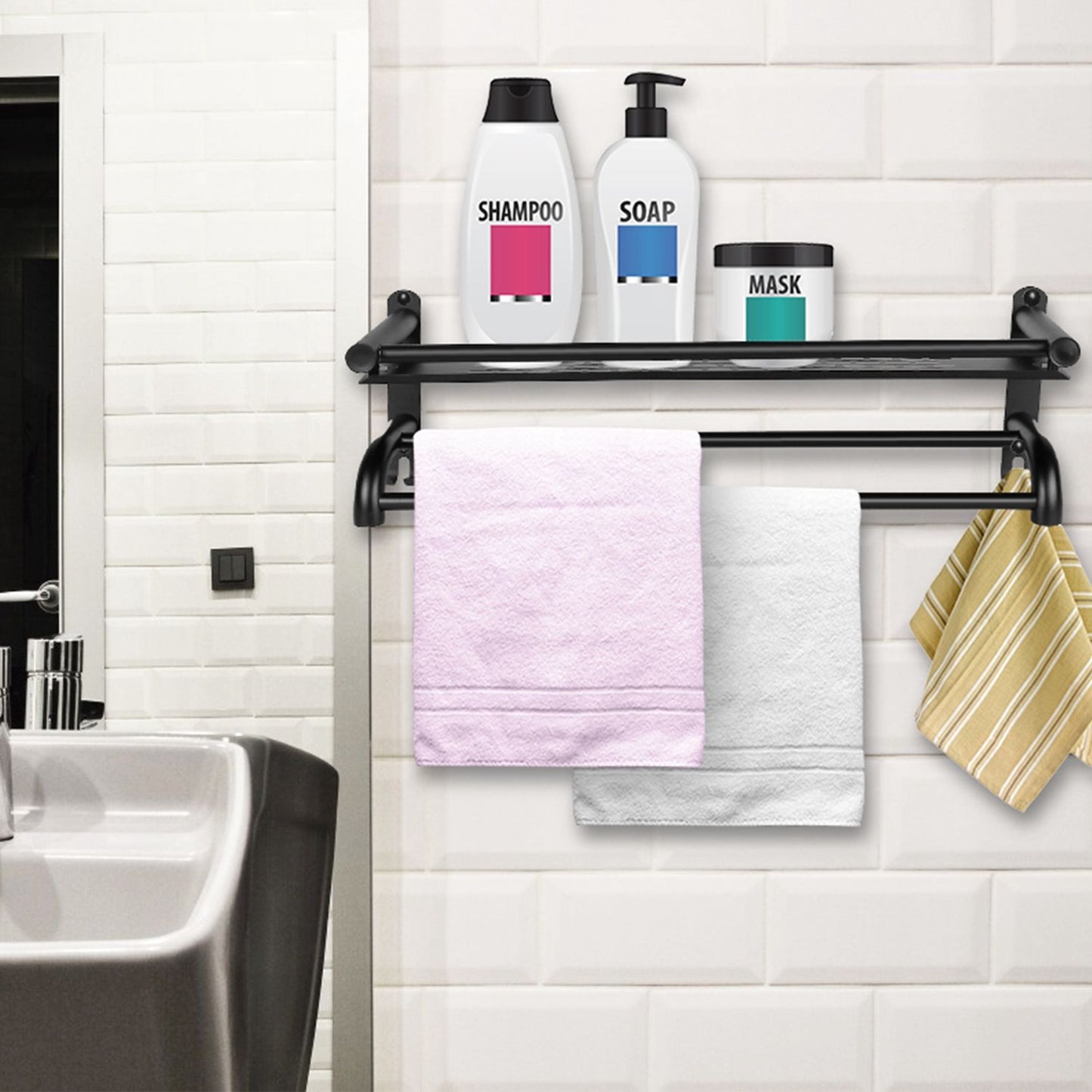Modern bathroom shelf with shampoo, soap, and mask containers, featuring three hanging towels: pink, white, and yellow striped, against a white tiled wall.