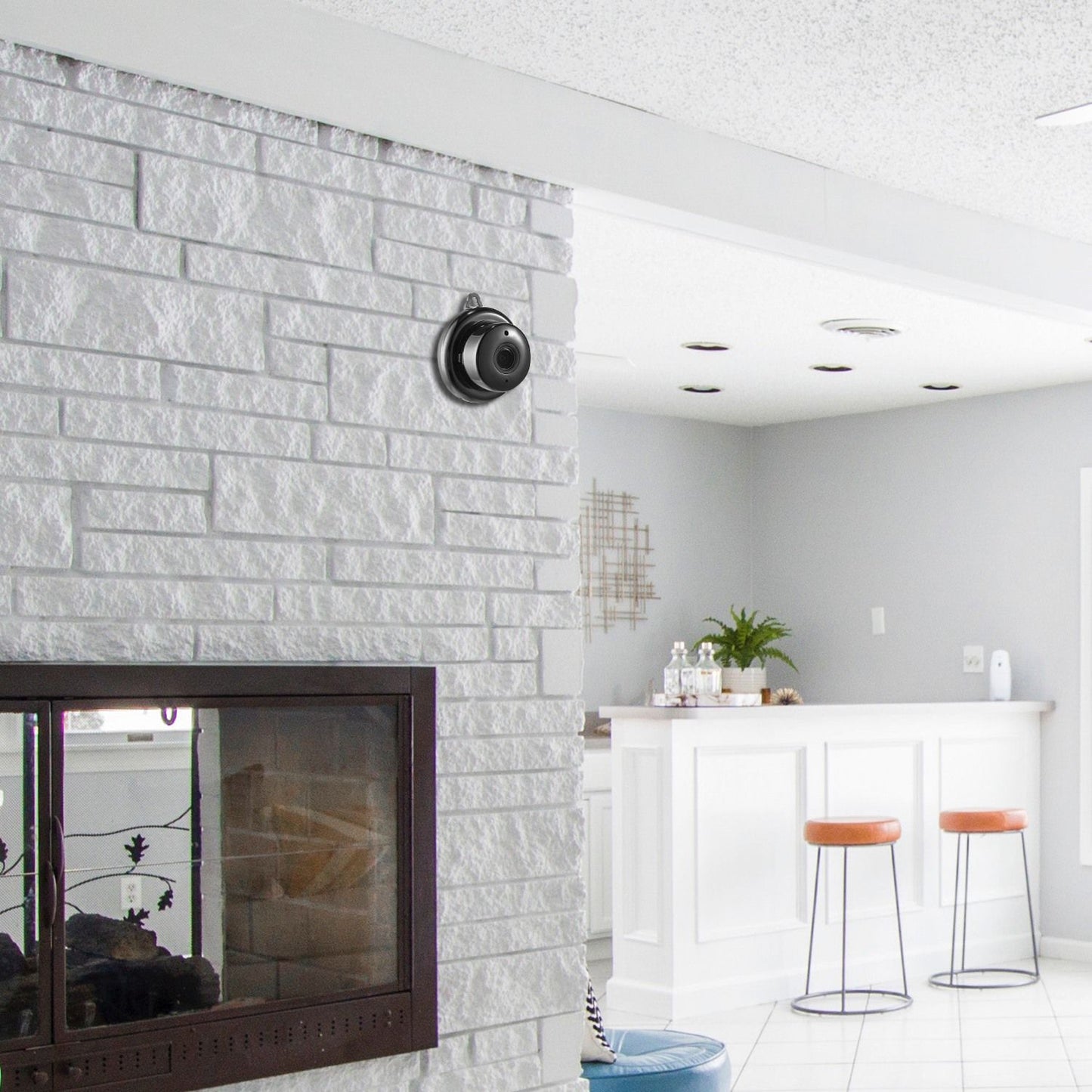 Stylish black security camera mounted on textured white brick wall in modern living space with a home bar and light grey decor.