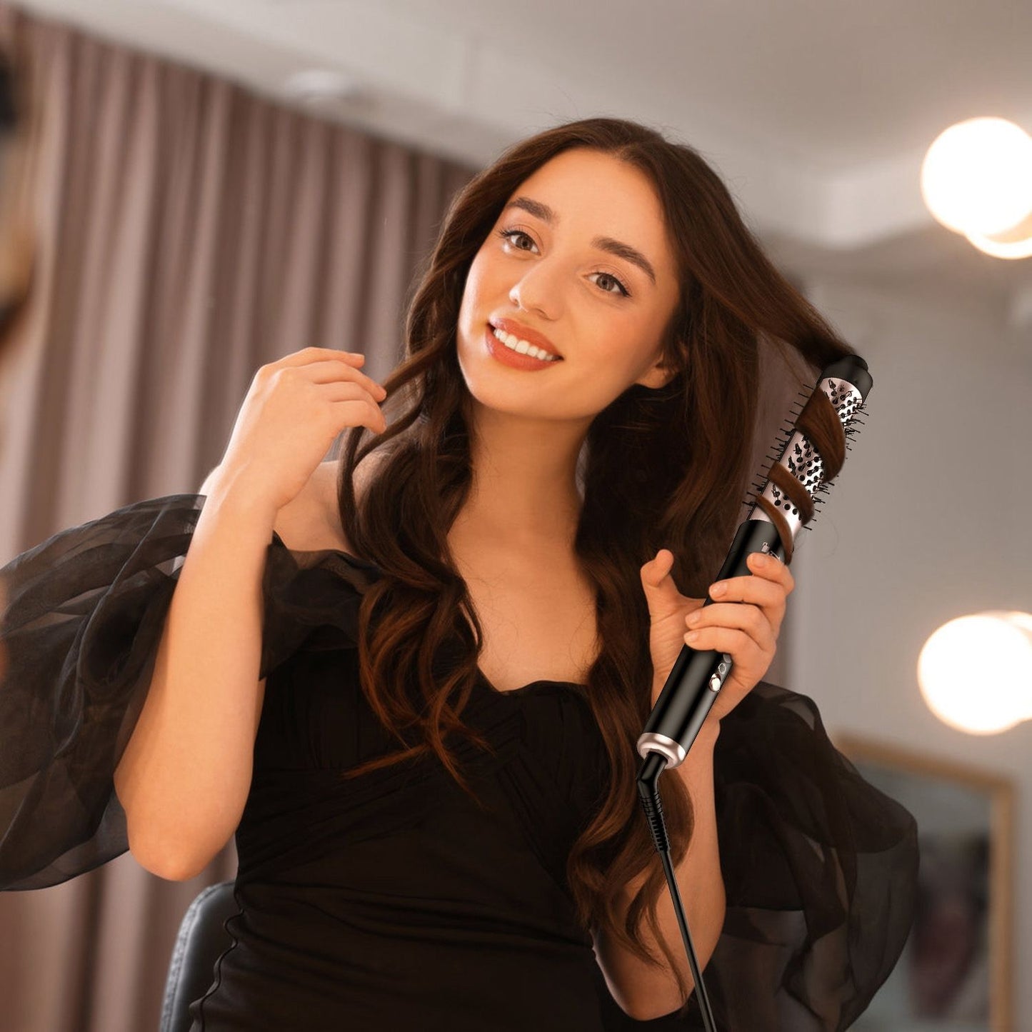 Woman styling her hair with a stylish, professional hair curling wand in a beauty salon setting, wearing a black off-shoulder dress with soft lighting and elegant décor.