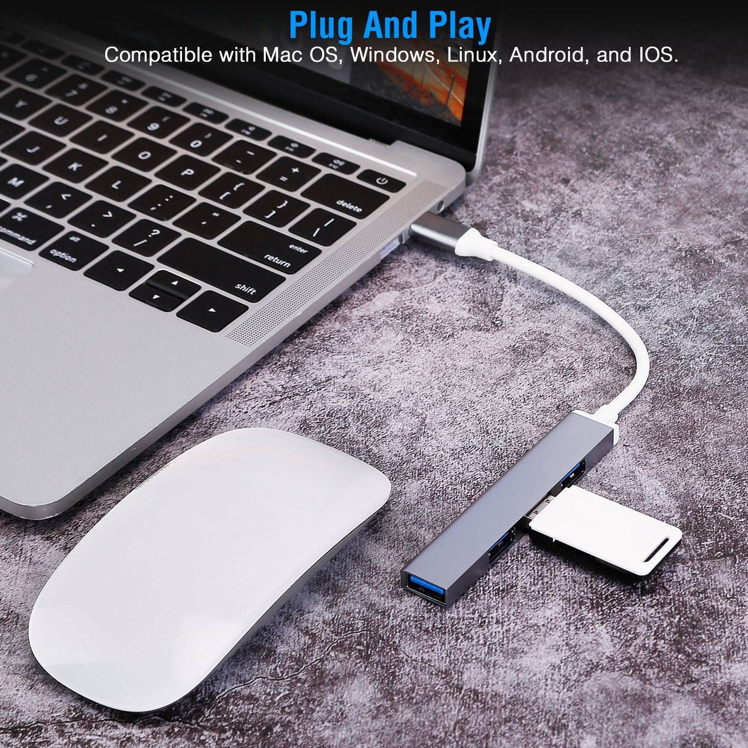 USB hub connected to a laptop, featuring multiple ports and a card reader, with a wireless mouse on a textured surface, highlighting its plug-and-play compatibility with various operating systems.