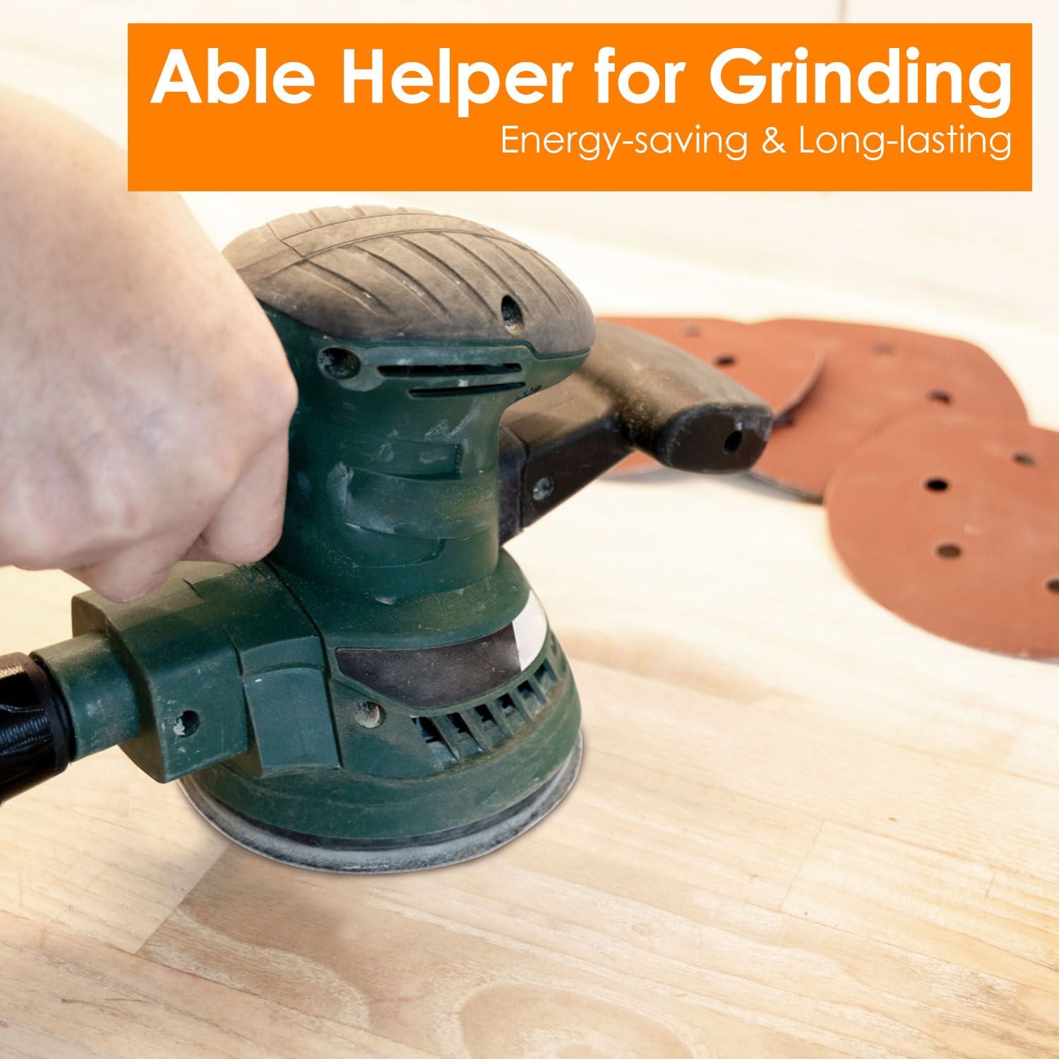 Image of a person using an energy-saving green orbital sander on a wooden surface, with sanding discs nearby, showcasing a practical tool for grinding and finishing projects.