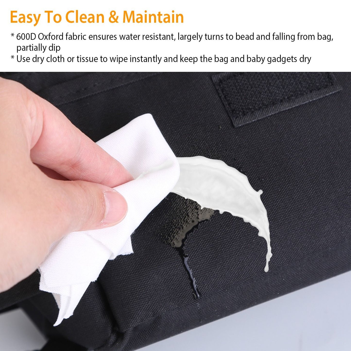 Person using a cloth to wipe a water-resistant black 600D Oxford fabric bag, demonstrating easy cleaning and maintenance for baby gadgets.