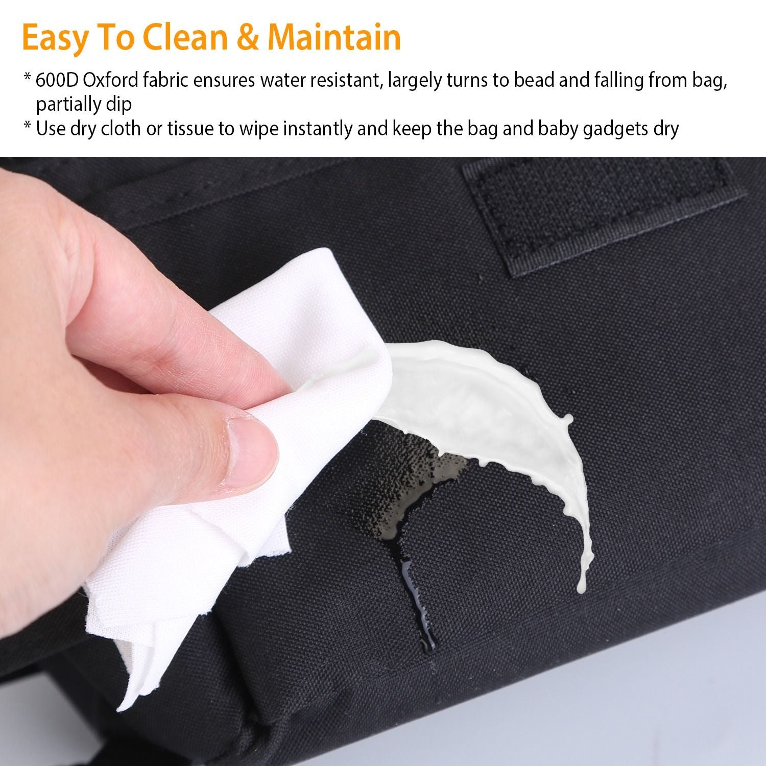 Person using a cloth to wipe a water-resistant black 600D Oxford fabric bag, demonstrating easy cleaning and maintenance for baby gadgets.