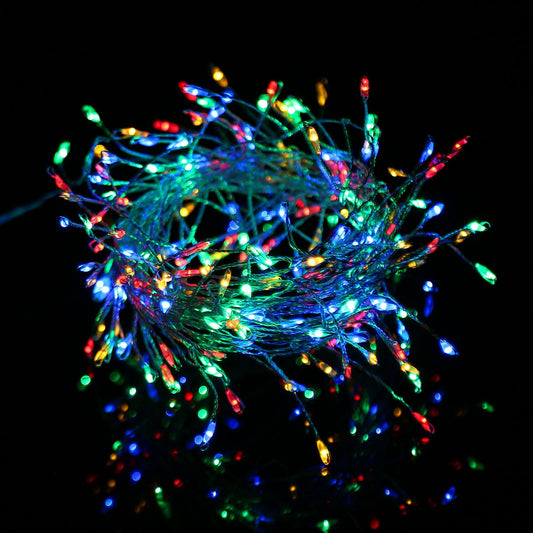 Colorful LED string lights in a tangled bundle, featuring vibrant red, green, blue, and yellow bulbs shining against a dark background, ideal for festive decorations and ambiance.
