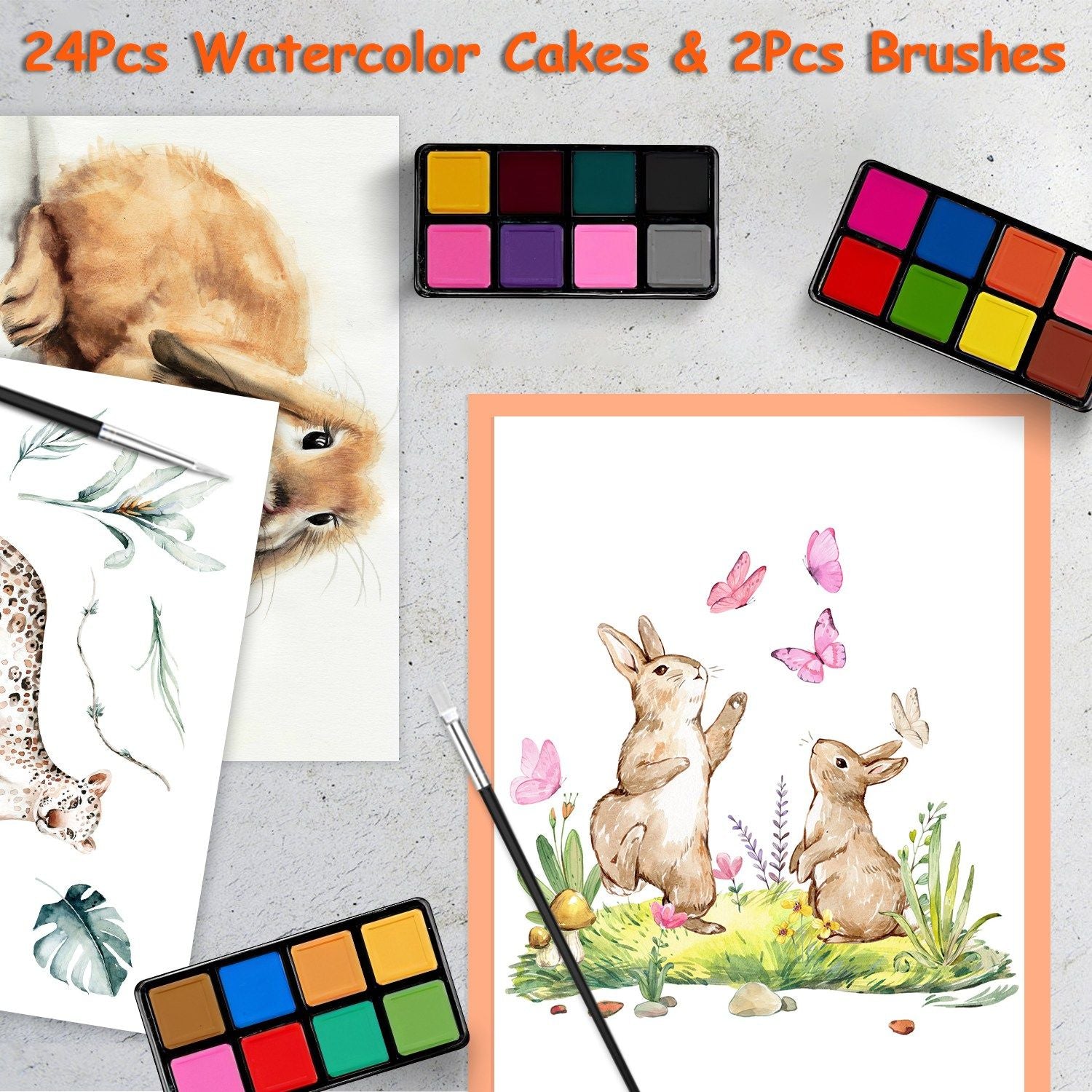 Watercolor art supplies including 24 watercolor cakes in vibrant colors and 2 brushes, with two bunny illustrations and a floral design on paper.