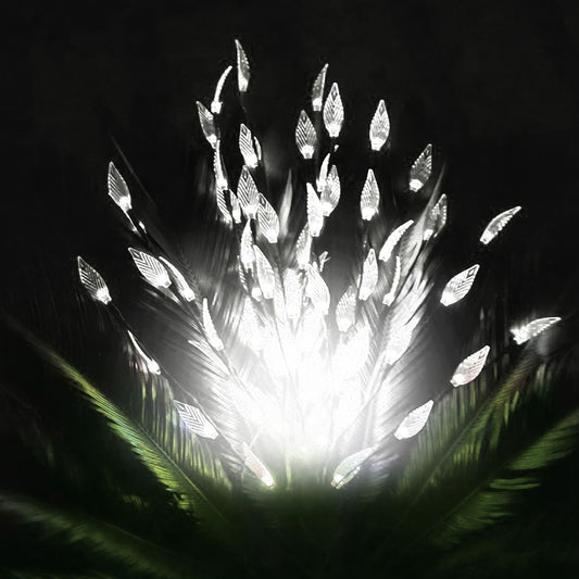 LED feather light display emitting a bright white glow against a dark background, surrounded by green foliage for an elegant decorative effect.